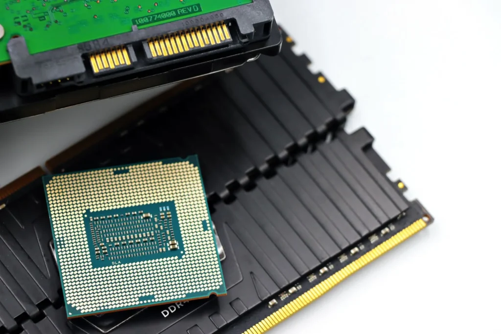 A processor resting on memory modules beside the SATA connectors of a hard drive.