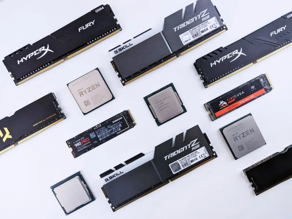 An assortment of desktop memory modules, processors, and M.2 solid-state drives arranged on white.